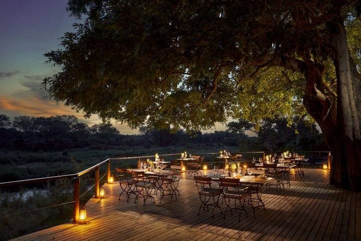Dining deck at dusk, Lion Sands Tinga Lodge